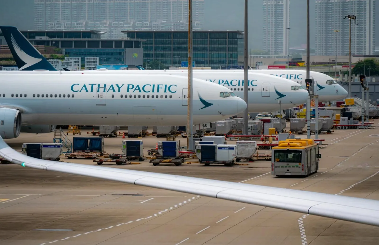 Passenger aircraft, air cargo containers and ground vehicles on an airport apron