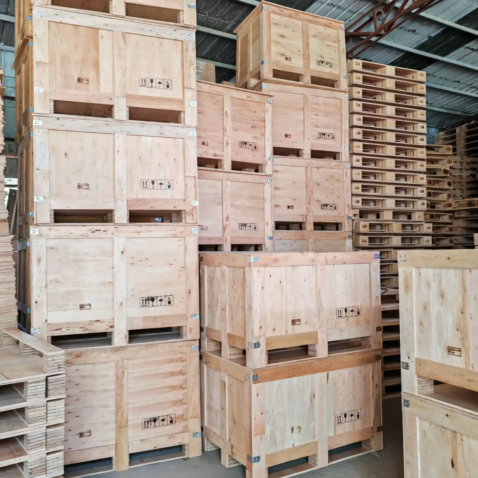 Wooden shipping crates and stacked pallets in a warehouse work area
